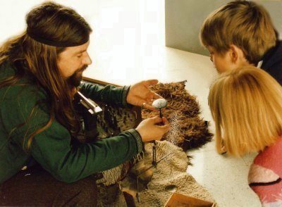 Explaining how a Viking brooch is decorated. Part of a demonstration showing how the Vikings and Saxons worked with silver to produce jewellery and artefacts